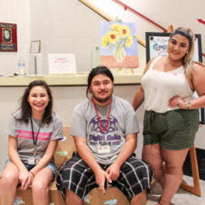 Victor Seguin (middle) with his former We 'Ced Youth Media mentor Crystal Rivera (right) and We 'Ced reporter Hannah Esqueda (left) at the Multicultural center in Merced Calif.